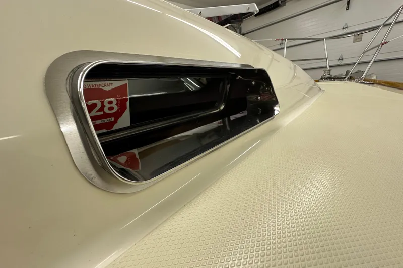 Slide: The Image of Close-up of a 2007 Sabre 386 yacht window with textured deck surface. - 78