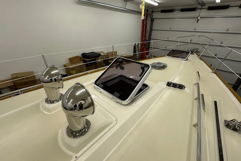 Slide: The Image of 2007 Sabre 386 yacht deck with chrome vents and open hatch in a garage. - 83