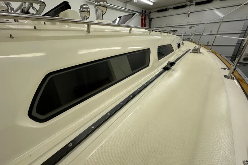 Slide: The Image of 2007 Sabre 386 yacht deck with sleek windows and polished railings in a garage setting. - 84