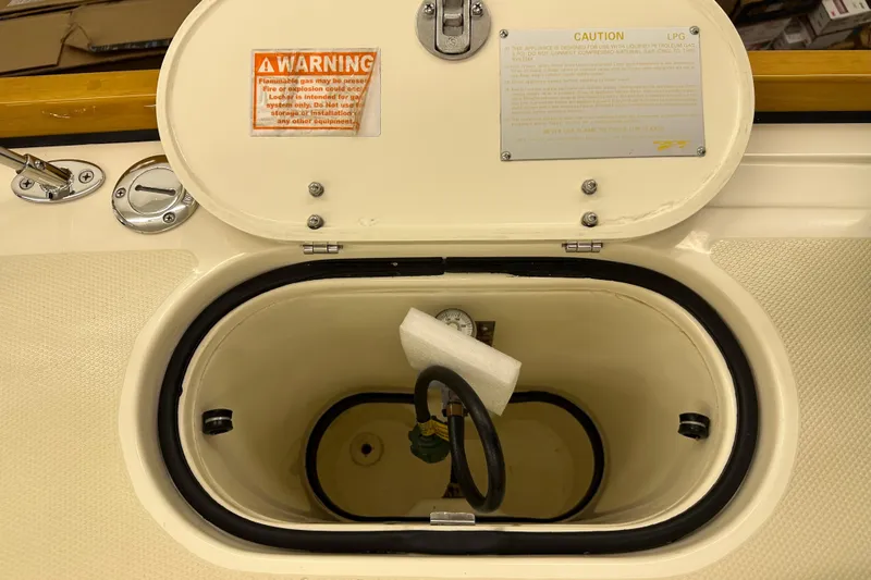Slide: The Image of Open LPG compartment on 2007 Sabre 386 boat with warning labels visible. - 87