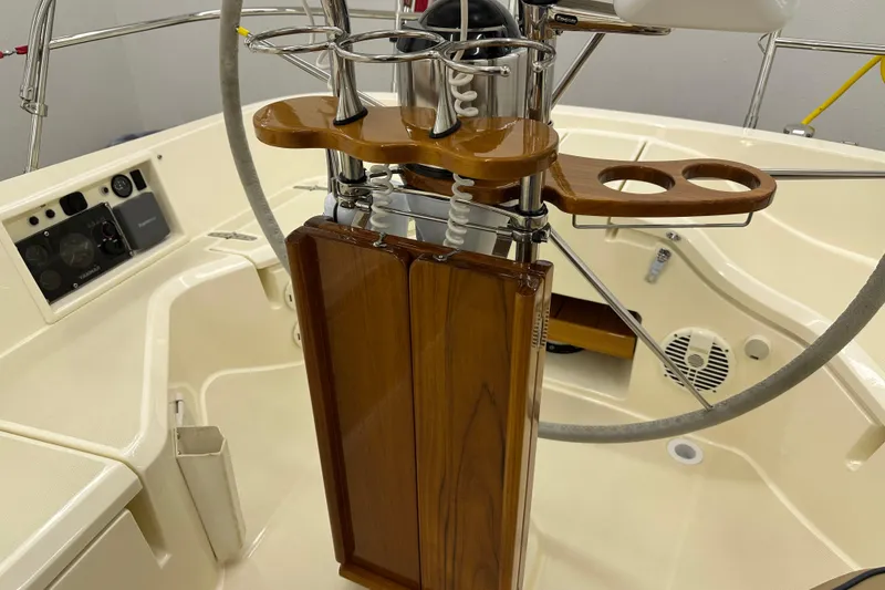 Slide: The Image of Steering console of a 2007 Sabre 386 sailboat with wooden accents and control panel. - 90