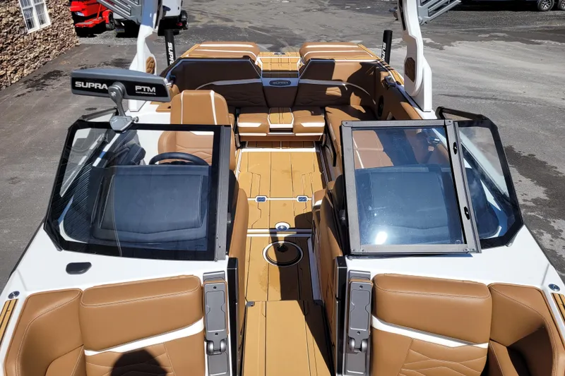 Slide: The Image of 2026 Supra SV 400 boat interior with tan leather seats and open windshield. - 13