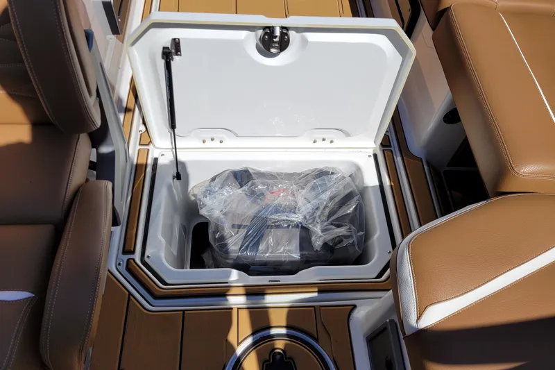 Slide: The Image of Open storage compartment in 2026 Supra SV 400 boat with brown seating. - 18