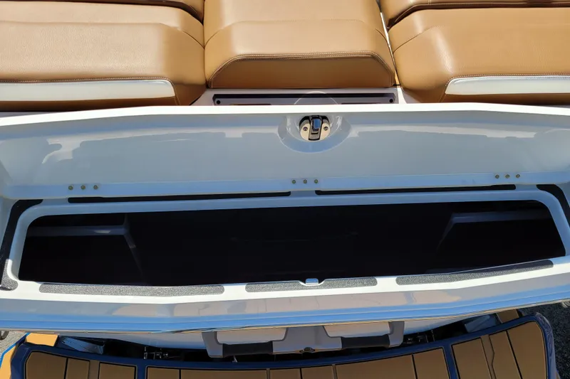 Slide: The Image of Open storage compartment in 2026 Supra SV 400 boat with tan seating. - 20