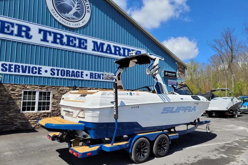 Slide: The Image of 2026 Supra SV 400 boat at Deer Tree Marine dealership, sunny day. - 6