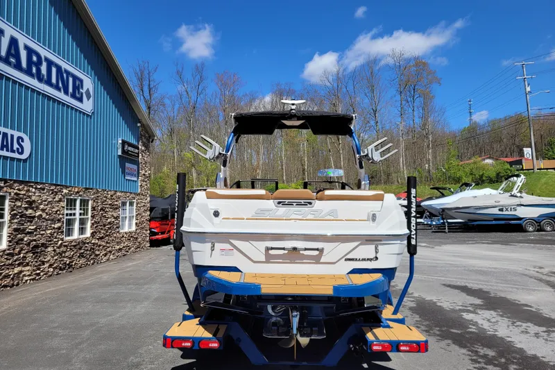 Slide: The Image of 2026 Supra SV 400 boat at a marina, showcasing sleek design and modern features. - 7