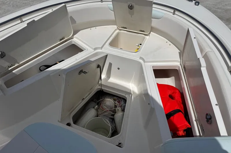 Slide: The Image of 2018 Robalo R242 Center Console with open storage compartments and life jacket. - 11