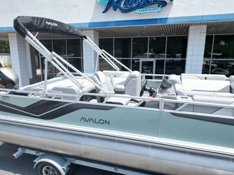 Slide: The Image of Avalon VNT VRB21 pontoon boat 2026 in front of a building. - 14