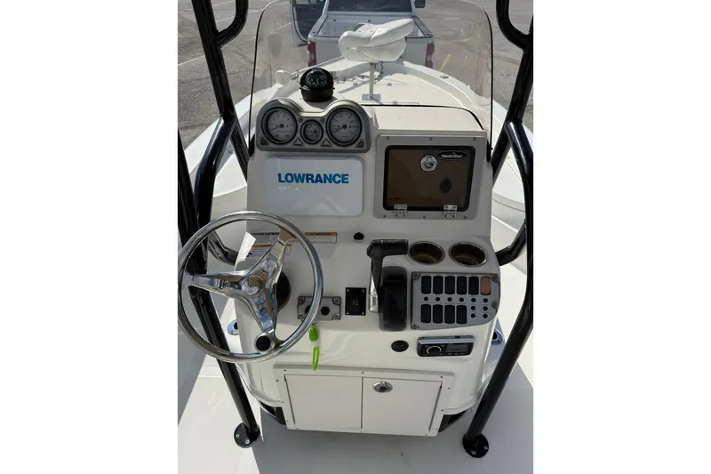 Slide: The Image of 2015 NauticStar 224 XTS boat console with steering wheel and Lowrance electronics. - 3
