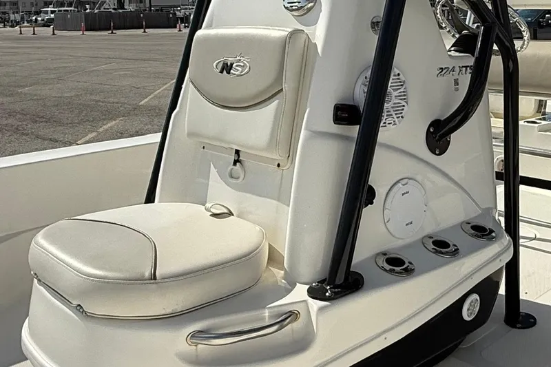 Slide: The Image of 2015 NauticStar 224 XTS boat console with seating and storage compartments. - 4