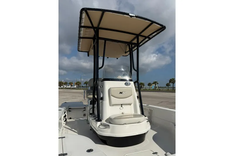 Slide: The Image of 2015 NauticStar 224 XTS boat with T-top, parked on a sunny day. - 6