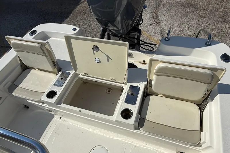 Slide: The Image of 2015 NauticStar 224 XTS boat interior with open storage compartments and seating. - 8