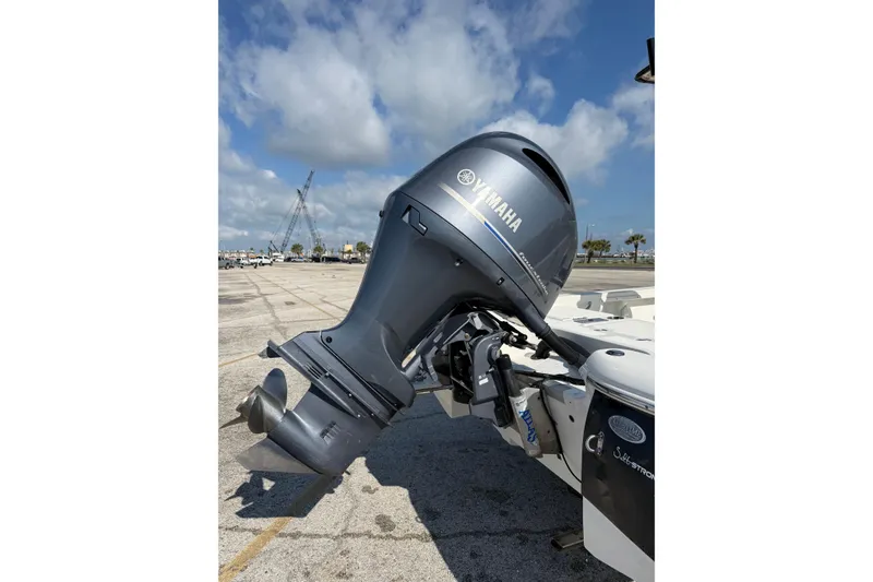 Slide: The Image of 2015 NauticStar 224 XTS with Yamaha outboard motor in a parking lot. - 9
