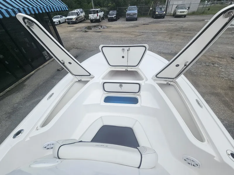 Slide: The Image of 2026 Tidewater 2110BMT boat with open storage compartments on parking lot. - 13