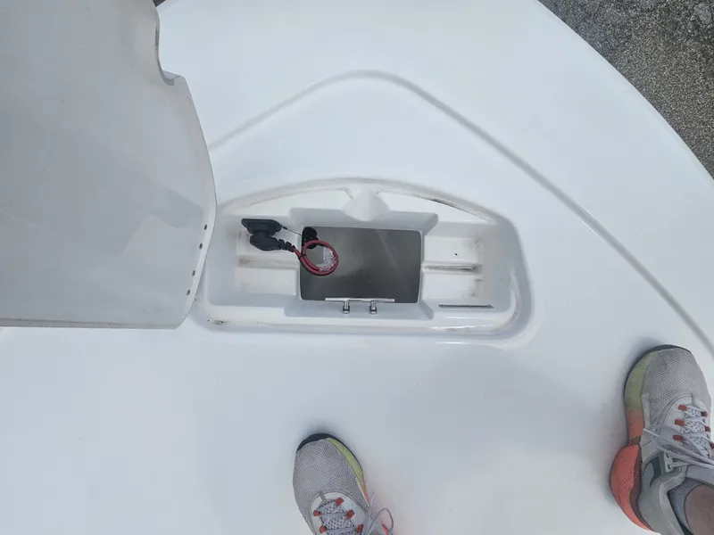 Slide: The Image of Tidewater 2110BMT 2026 boat deck with storage compartment and shoes. - 16