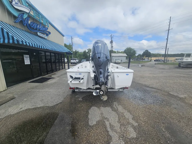 Slide: The Image of 2026 Tidewater 2110BMT boat at a marine dealership. - 6