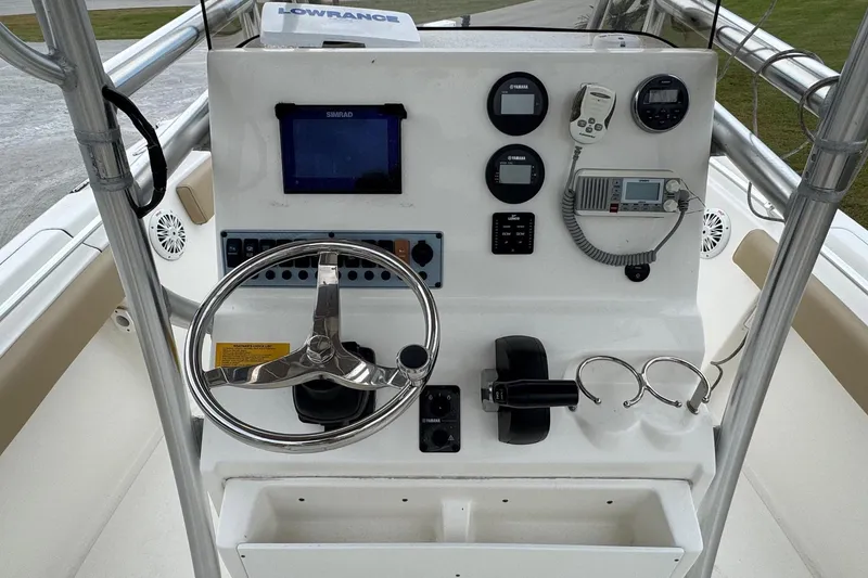Slide: The Image of 2019 Key West 219 FS boat console with steering wheel and instruments. - 19