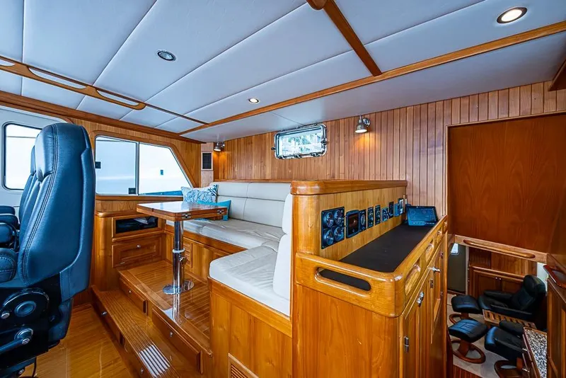 Slide: The Image of Luxurious 2016 Kadey-Krogen 52 yacht interior with wood paneling and plush seating. - 15