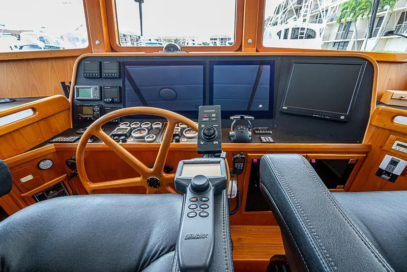 Slide: The Image of Helm of 2016 Kadey-Krogen 52 yacht with navigation controls and displays. - 23