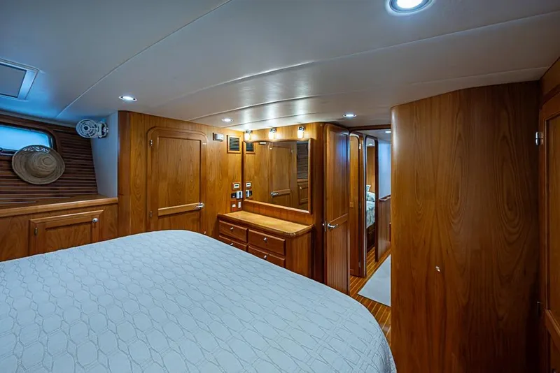 Slide: The Image of Luxurious 2016 Kadey-Krogen 52 yacht bedroom with elegant wood paneling and ambient lighting. - 28