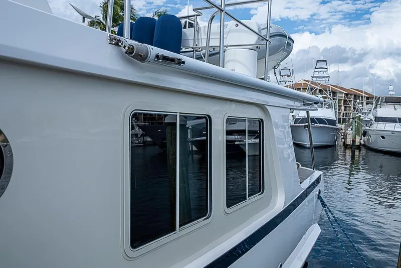 Slide: The Image of 2016 Kadey-Krogen 52 yacht docked at marina, showcasing sleek design and windows. - 71