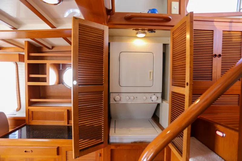 Slide: The Image of 2008 Kadey-Krogen 48 North Sea yacht interior with washer-dryer and wooden cabinetry. - 12