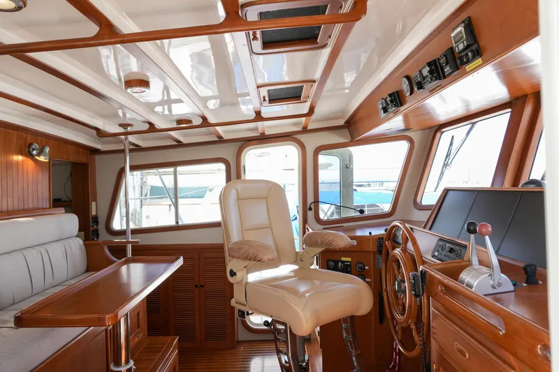 Slide: The Image of Luxurious 2008 Kadey-Krogen 48 North Sea yacht interior with helm, seating, and wooden accents. - 14