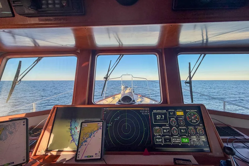 Slide: The Image of Pilothouse view from 2008 Kadey-Krogen 48 North Sea yacht, featuring navigation instruments and ocean horizon. - 18