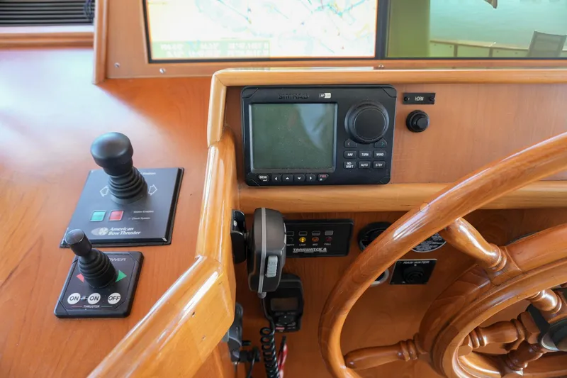 Slide: The Image of Kadey-Krogen 48 North Sea 2008 helm with navigation controls and wooden steering wheel. - 20