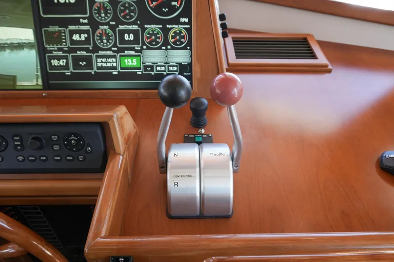 Slide: The Image of Control panel of 2008 Kadey-Krogen 48 North Sea yacht with throttle levers and digital displays. - 22