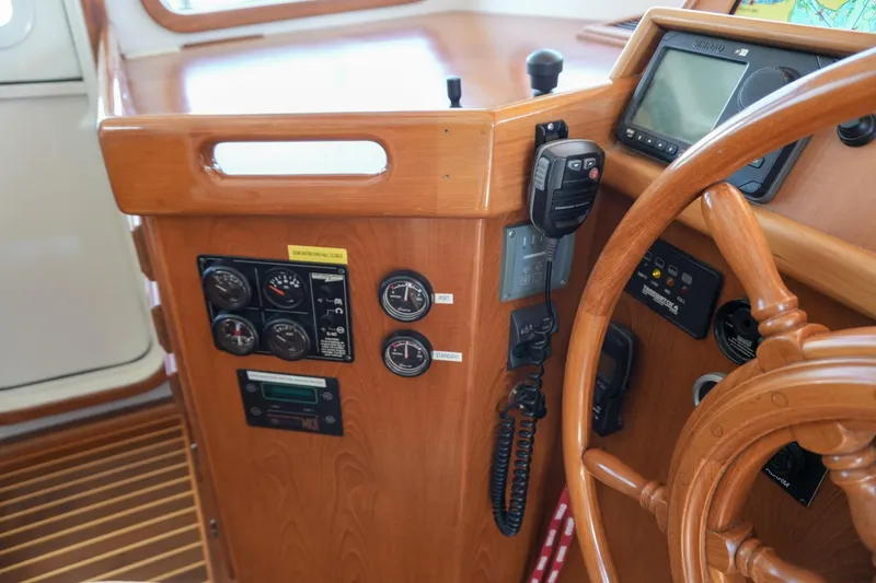 Slide: The Image of 2008 Kadey-Krogen 48 North Sea helm with wooden wheel and navigation instruments. - 26