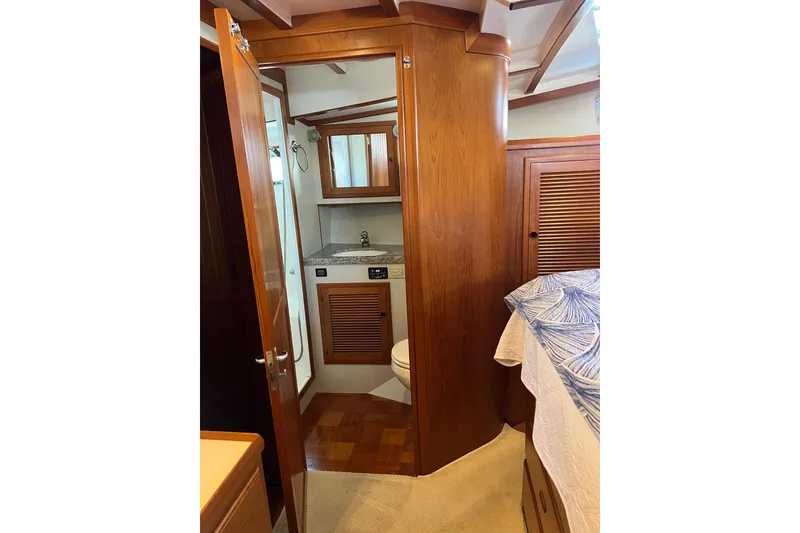 Slide: The Image of 2008 Krogen 48 North Sea yacht interior with wooden cabinetry and compact bathroom. - 36