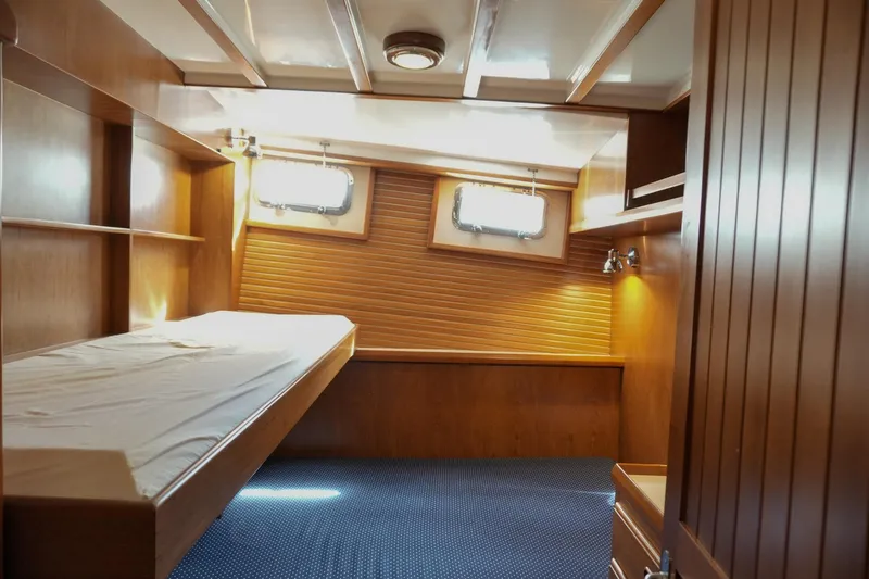 Slide: The Image of 2008 Kadey-Krogen 48 North Sea cabin interior with wooden finish and single bed. - 38