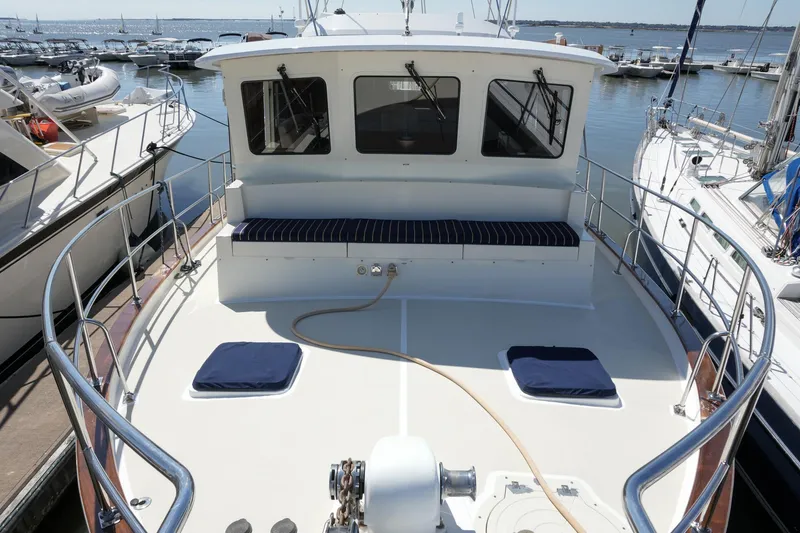 Slide: The Image of 2008 Kadey-Krogen 48 North Sea yacht docked, featuring spacious deck and seating area. - 45