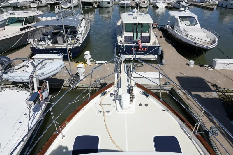 Slide: The Image of 2008 Kadey-Krogen 48 North Sea yacht docked among other boats in a marina. - 46