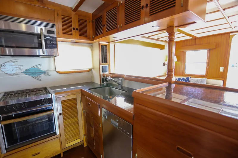 Slide: The Image of 2008 Kadey-Krogen 48 North Sea yacht kitchen with wood cabinetry and modern appliances. - 9