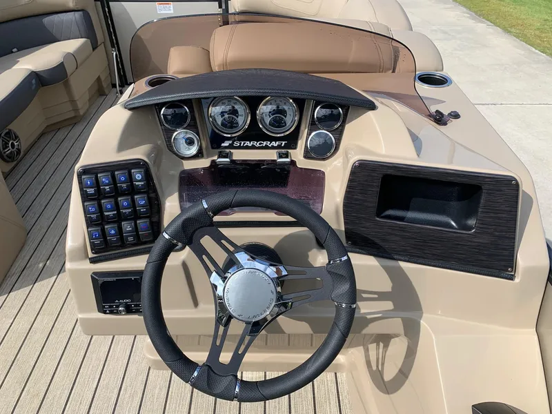 Slide: The Image of Dashboard of a 2021 Starcraft SLS 3 boat with steering wheel and gauges. - 6