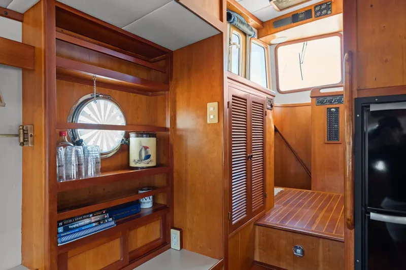 Slide: The Image of Interior of 1999 Kadey-Krogen 39 yacht with wooden shelves and nautical decor. - 10