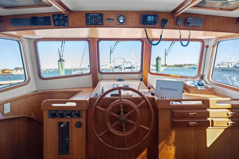 Slide: The Image of Pilothouse of 1999 Kadey-Krogen 39 yacht with wooden helm and Garmin navigation. - 15