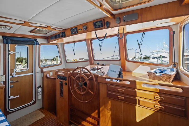 Slide: The Image of Interior of 1999 Kadey-Krogen 39 boat with wooden helm and navigation equipment. - 16