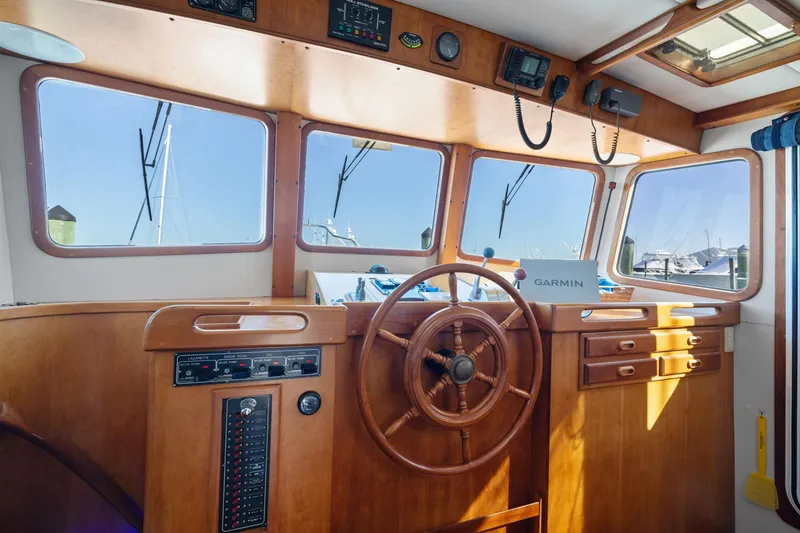 Slide: The Image of 1999 Kadey-Krogen 39 boat helm with wooden steering wheel and Garmin navigation system. - 17