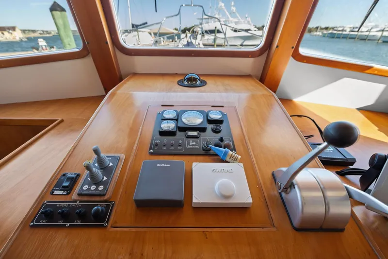 Slide: The Image of 1999 Kadey-Krogen 39 yacht helm with navigation controls and ocean view. - 18