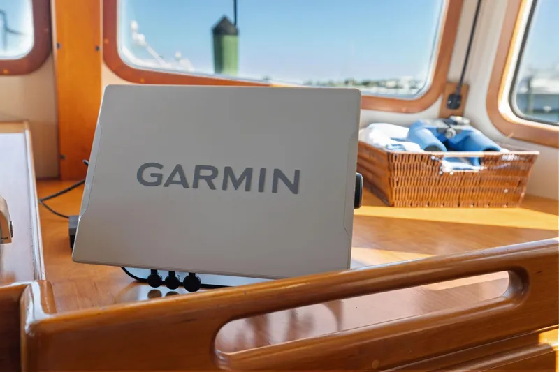 Slide: The Image of Garmin device on 1999 Kadey-Krogen 39 yacht, wooden interior, basket with binoculars. - 19