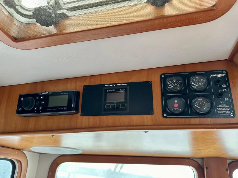 Slide: The Image of Control panel of a 1999 Kadey-Krogen 39 boat with navigation and monitoring instruments. - 22