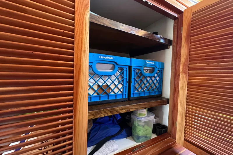 Slide: The Image of Wooden cabinet with blue CleverMade crates inside a 1999 Kadey-Krogen 39 boat. - 26