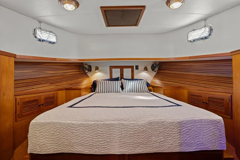 Slide: The Image of Luxurious 1999 Kadey-Krogen 39 yacht cabin with cozy bed and elegant wood paneling. - 28