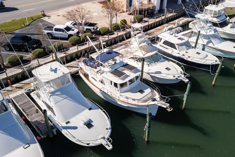 Slide: The Image of Aerial view of a 1999 Kadey-Krogen 39 yacht docked among other boats. - 3