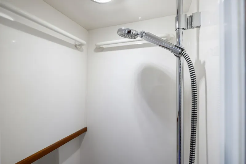 Slide: The Image of Shower area in 1999 Kadey-Krogen 39 yacht, featuring chrome fixtures and white walls. - 31