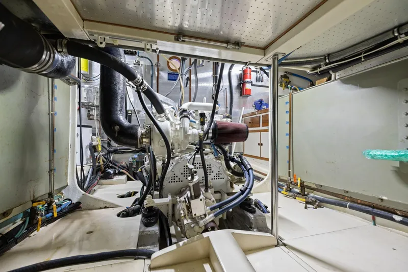 Slide: The Image of Engine room of a 1999 Kadey-Krogen 39 boat, showcasing mechanical components. - 34