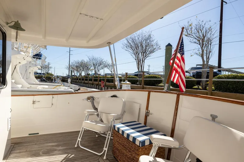 Slide: The Image of 1999 Kadey-Krogen 39 yacht deck with chairs and American flag. - 37